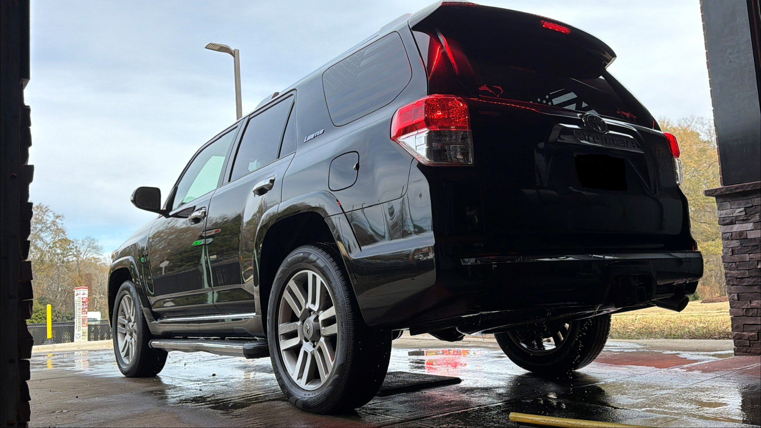A black 4Runner shining on the lot after its wash