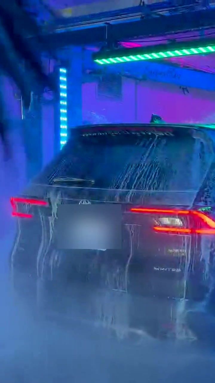 An SUV rolls through mist and blue light at the end of the tunnel